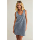 Model wearing Z Supply Sloane V-Neck Knit Denim Dress in Medium Indigo in front of a neutral background