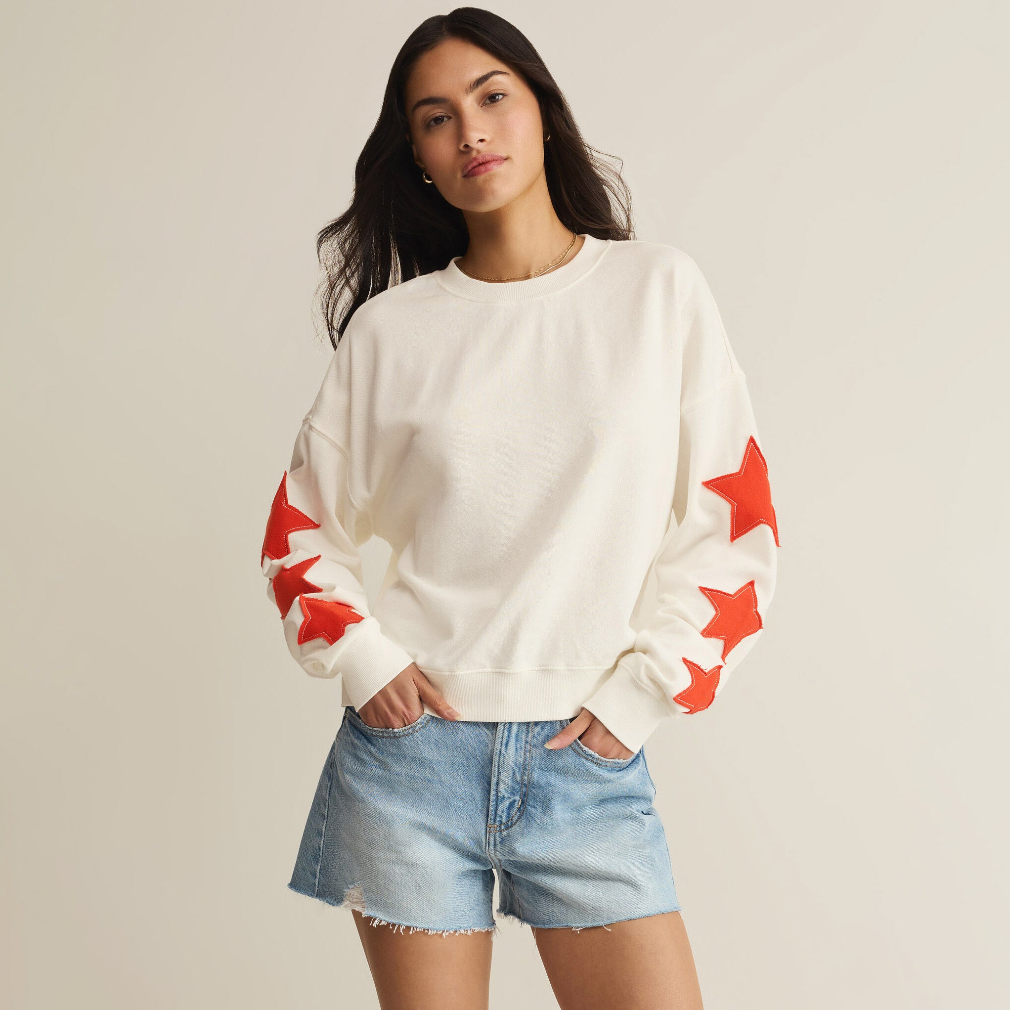 Woman wearing Z Supply Stars First Date Sweatshirt in Sea Salt on plain background at Addison West.