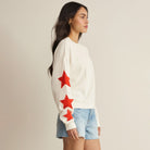 Woman wearing Z Supply Stars First Date Sweatshirt in Sea Salt on plain background at Addison West.