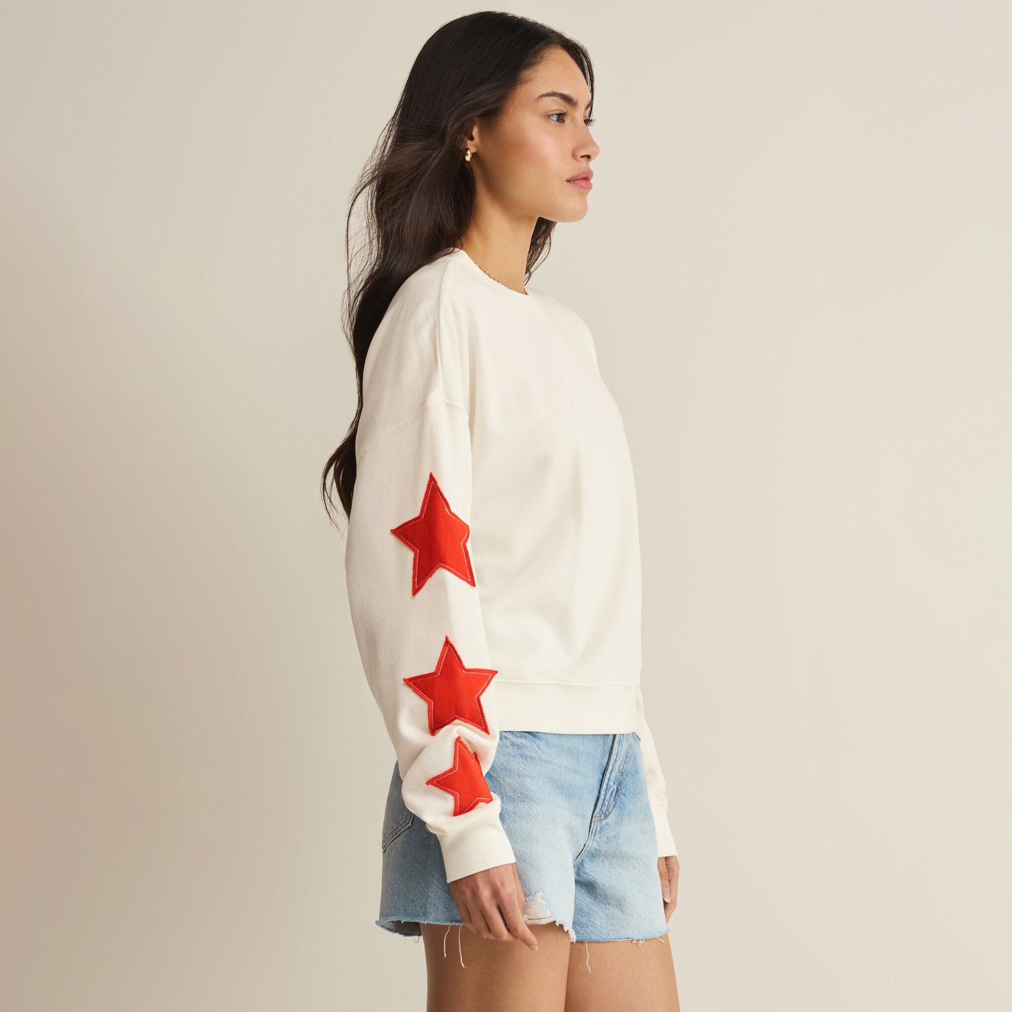 Woman wearing Z Supply Stars First Date Sweatshirt in Sea Salt on plain background at Addison West.