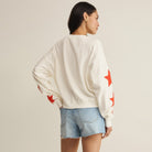 Woman wearing Z Supply Stars First Date Sweatshirt in Sea Salt on plain background at Addison West.