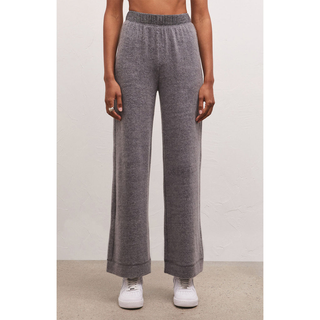 Model wearing white sneakers with Z Supply Tessa Cozy Pant In Charcoal Heather in front of a white wall