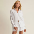 Woman wearing Z Supply The Perfect Airy Top in White on plain background at Addison West.