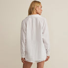 Woman wearing Z Supply The Perfect Airy Top in White on plain background at Addison West.