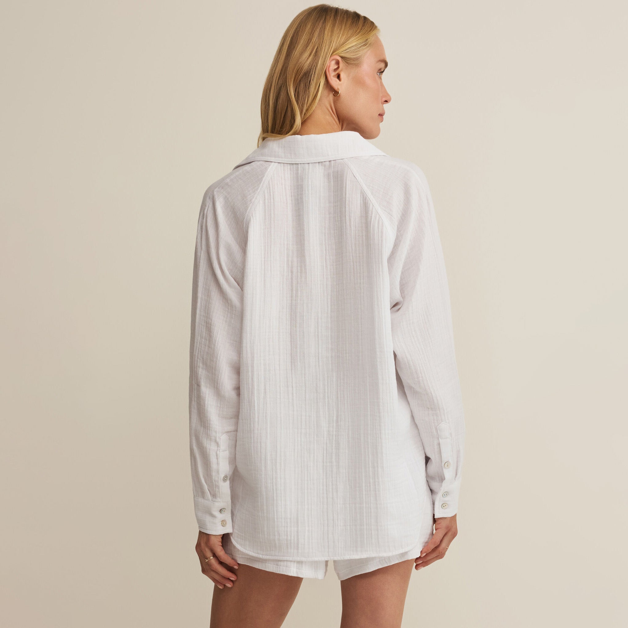 Woman wearing Z Supply The Perfect Airy Top in White on plain background at Addison West.