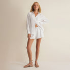 Woman wearing Z Supply The Perfect Airy Top in White on plain background at Addison West.