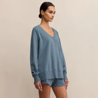 Woman wearing Z Supply Weekender V Neck in Boathouse on a beige background