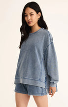 Model wearing Z Supply Knit Denim Modern Weekender in Medium Indigo in front of a neutral backdrop 