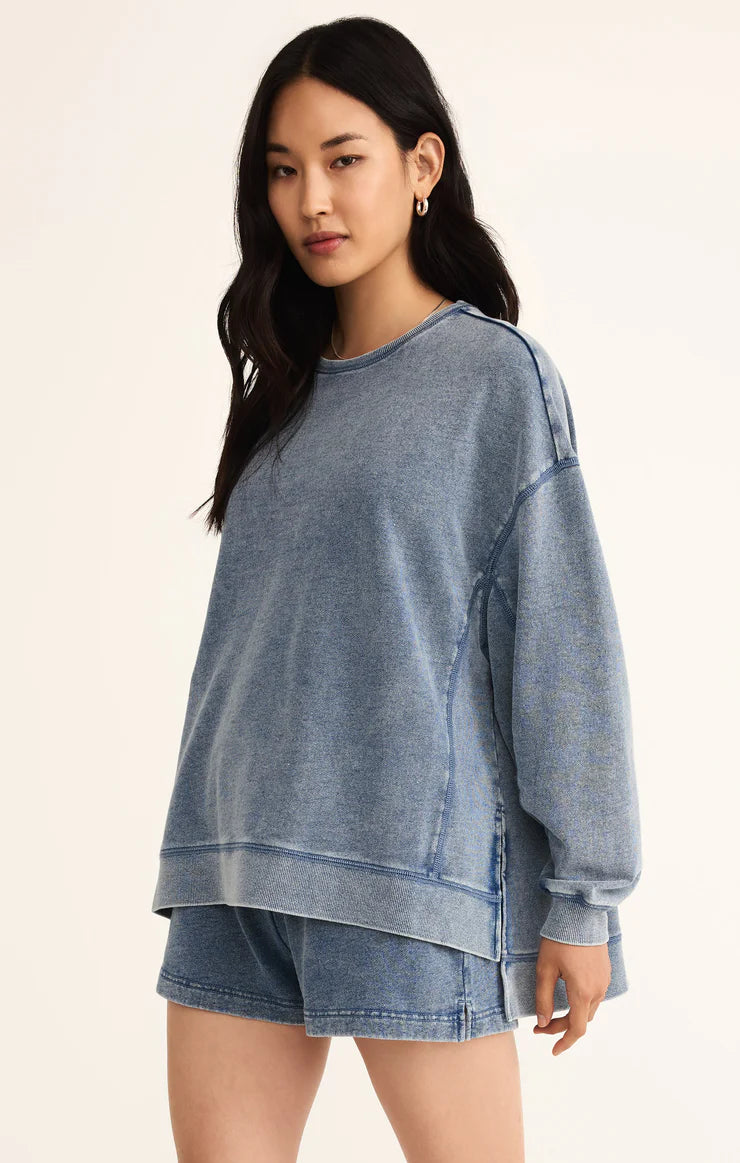Model wearing Z Supply Knit Denim Modern Weekender in Medium Indigo in front of a neutral backdrop 