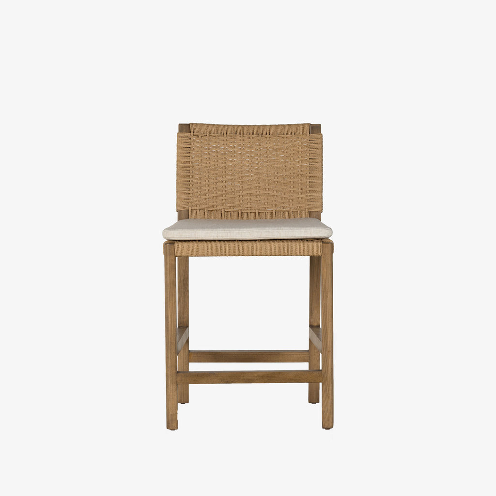 Four Hands Zuma counter stool with beige cushion and woven back in Dune Ash on a white background