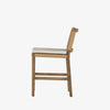 Four Hands Zuma counter stool with beige cushion and woven back in Dune Ash on a white background