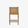 Four Hands Zuma counter stool with beige cushion and woven back in Dune Ash on a white background