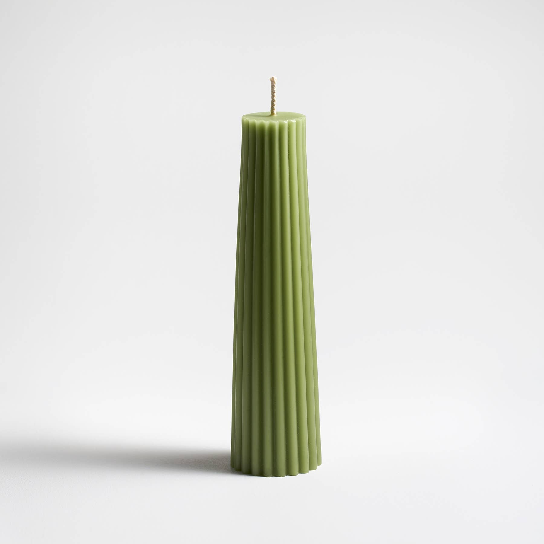 Greentree 8" Petite Pillar Candle in Sage on a white background at Addison West