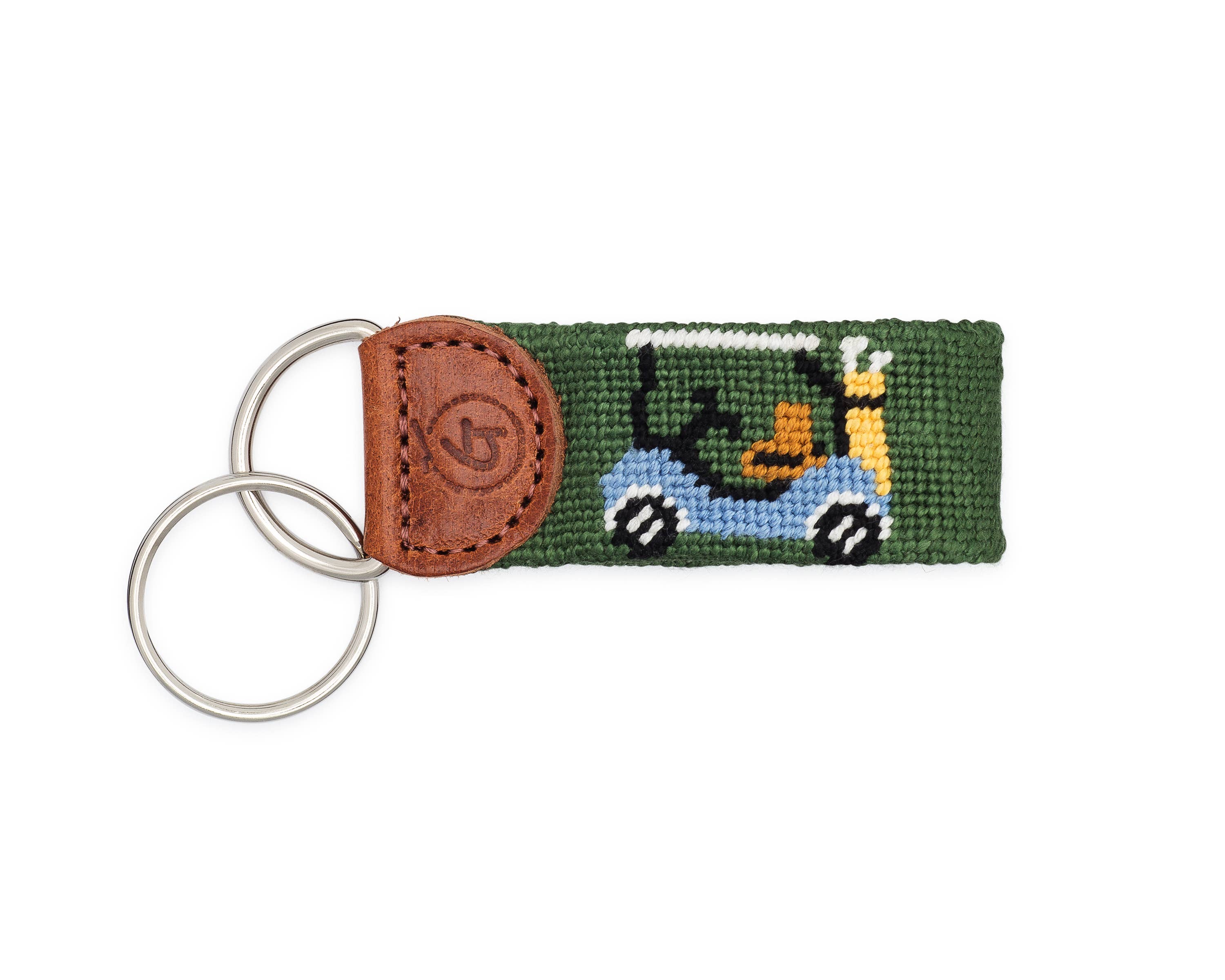 Keychain with green fabric strap featuring a golf cart and brown leather accent on a white background