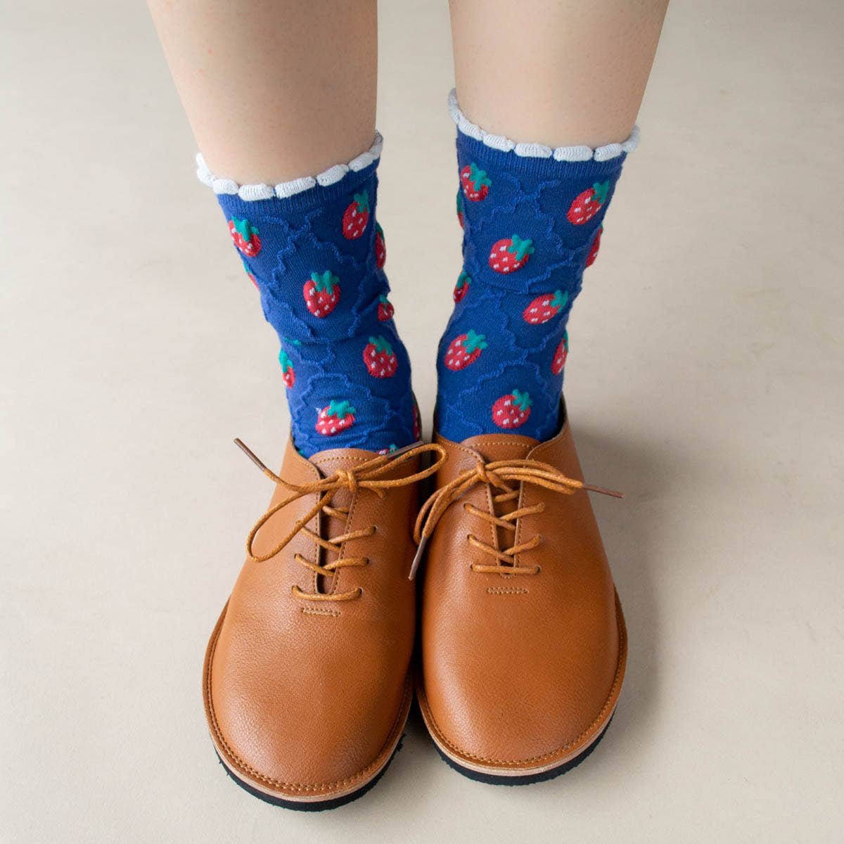 Retro Strawberry Socks in Blue on a model at Addison West