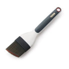 Zyliss Basting brush with a gray handle and black bristle head on a white background