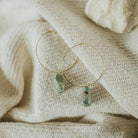 Commonform Aurora Hoops in Turquoise on textured background at the Addison West.