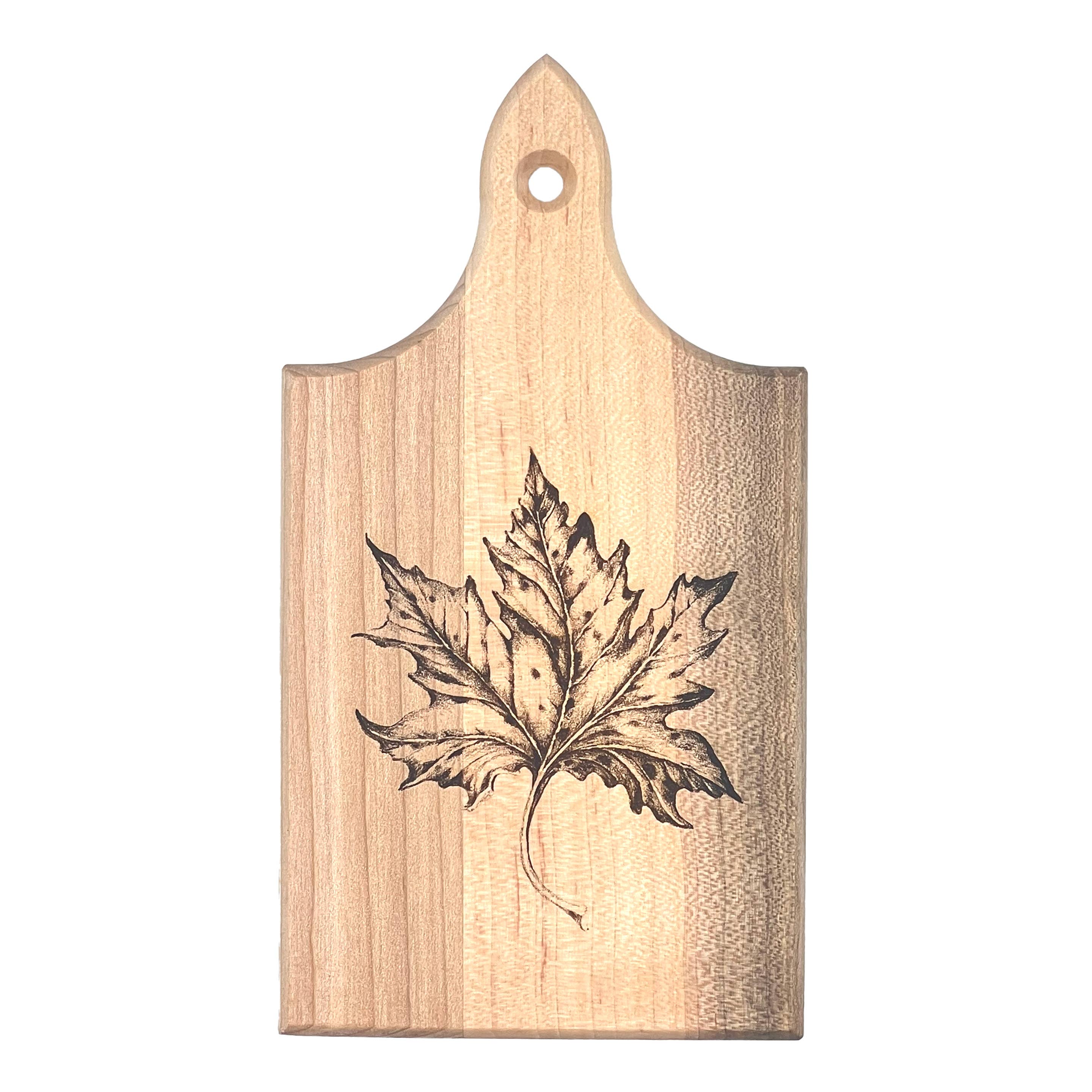 A rectangular wooden cutting board with a pointed top and a hanging hole, featuring a dark engraved maple leaf design on a light natural wood grain background.