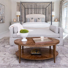 Stafford Oval Cocktail Table in Hazelnut Finish in a bedroom at Addison West