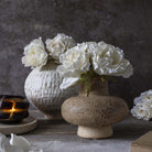 Abigail Ahern Faux Rose Bunch in White in a vase on a grey background at Addison West