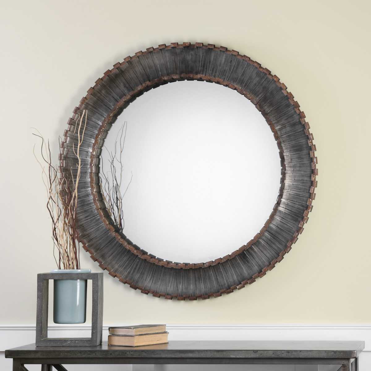 Tanner Round Accent Mirror on a yellow wall above a table at Addison West