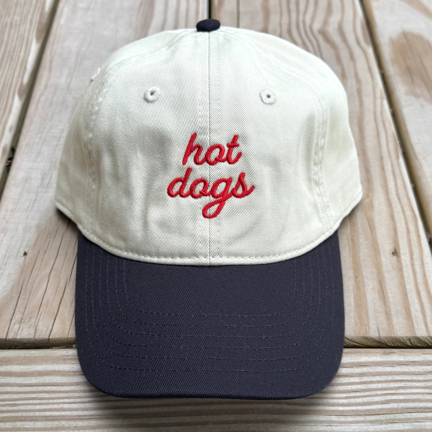 Hot Dog Baseball Hat in Khaki on a wood table at Addison West
