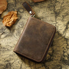 Zippered Small Leather Wallet in Dark Brown on a table at Addison West
