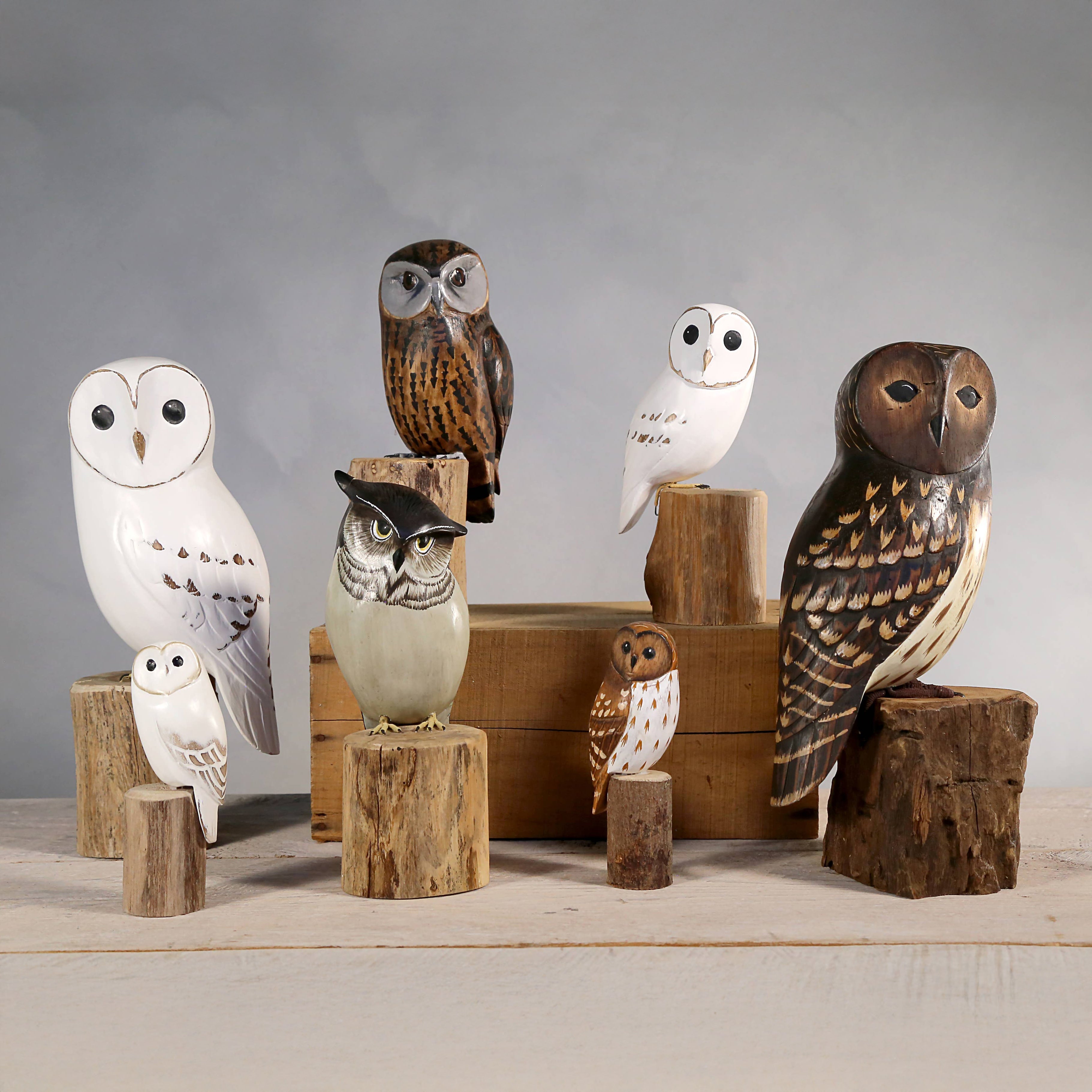 Hand Carved owl Ornaments on a grey background at Addison West