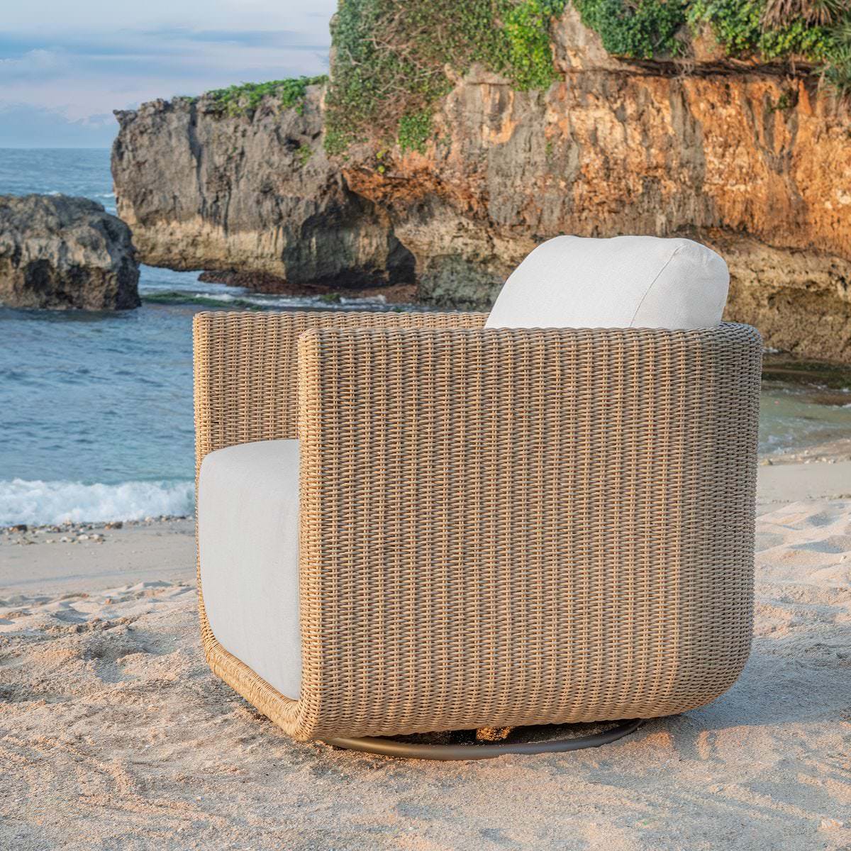 Saylor Outdoor Swivel Lounge Chair on a beach at Addison West