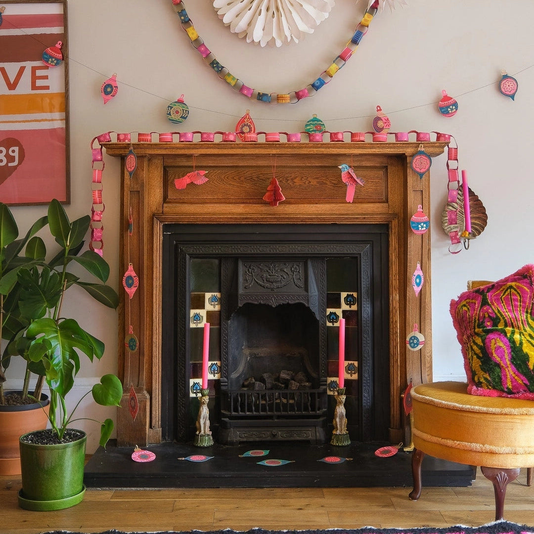 East End Press Pink & Red Paper Chain Kit on a fireplace at Addison West