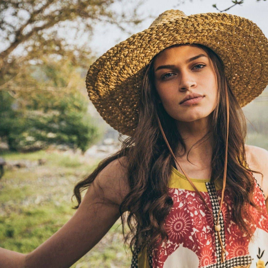 Skiff Sun Hat in Natural on model at the Addison West.
