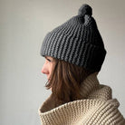 Knitting Craft Kit: Classic Pom Beanie in Medium Grey on a beige background at Addison West