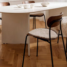 Short Wool Curly Sheepskin Seat Cover in Pearl on a dining chair at Addison West