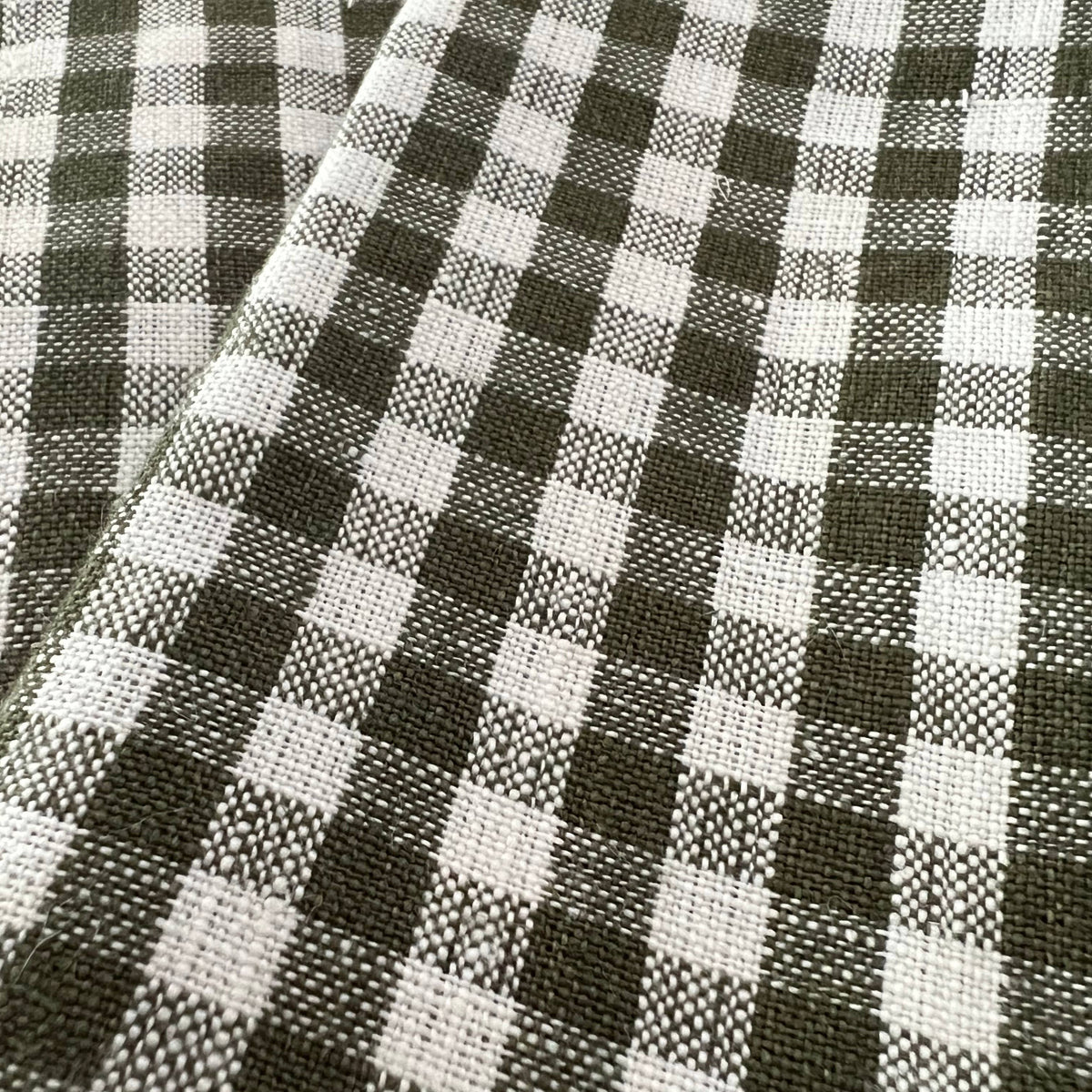 Olive Gingham Check Linen Tablecloth, 60" x 90" on a table at Addison West