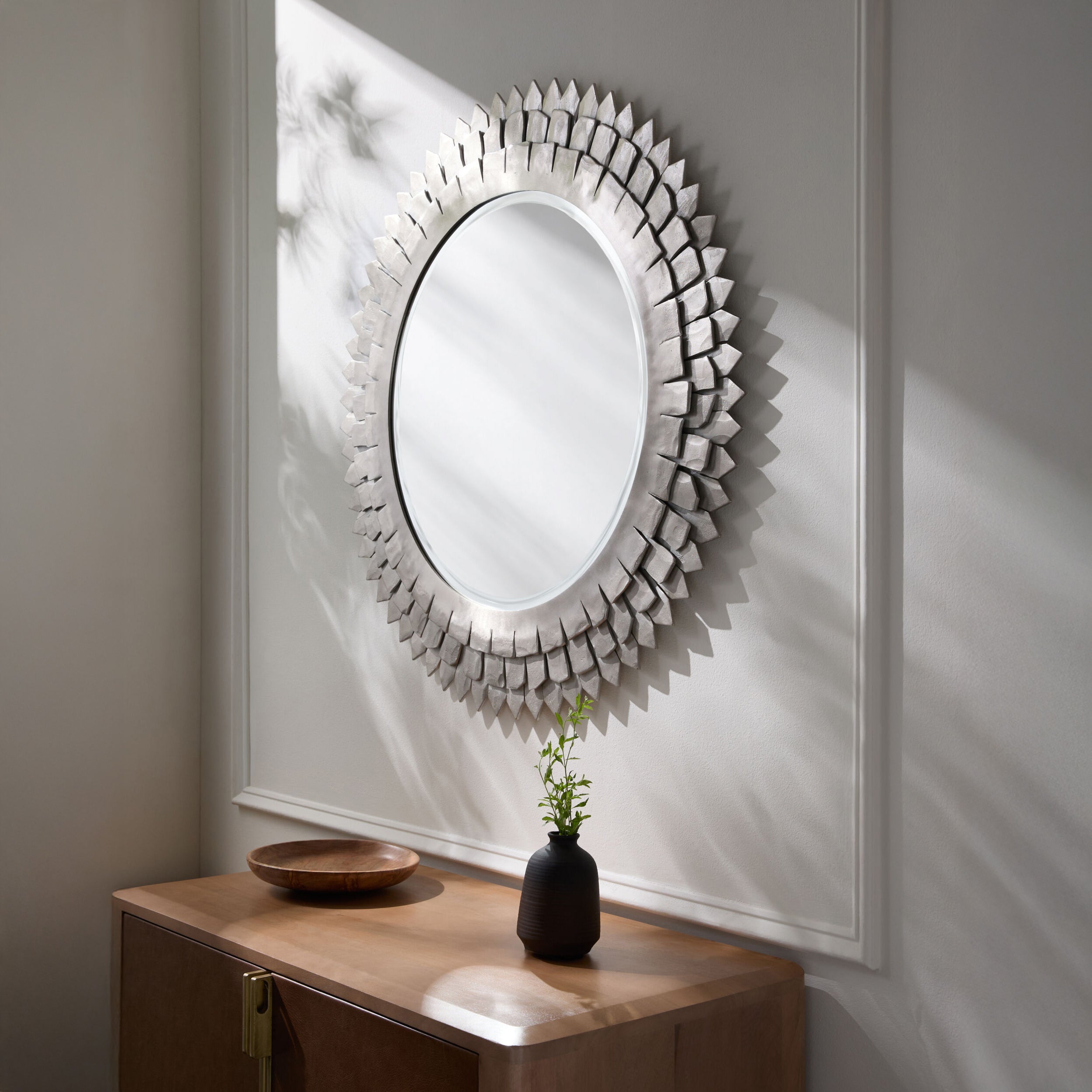 Cian Accent Mirror on a white background at Addison West on a white wall above a table at Addison West