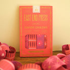 Packaged paper chains with 'East End Press' branding on a wooden surface.