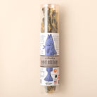 Tube of polkadog brand dog treats on a beige background