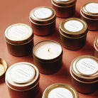 Eucalyptus + Lavender Mini Soy Candle on an orange background at Addison West