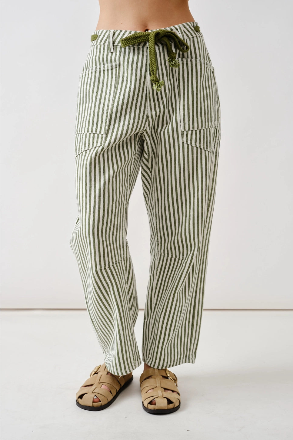 Model wearing green and white stripe barrel jeans with a drawstring on a white background