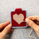 Heart Needlepoint Keychain Kit on a grey background at Addison West