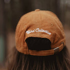 Barn Owl Corduroy Hat in Amber on a model outside at Addison West