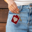 Heart Needlepoint Keychain Kit with a model at Addison West