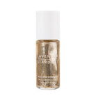 Gold bottle of Lavender Stardust roll-on shimmer on a white background
