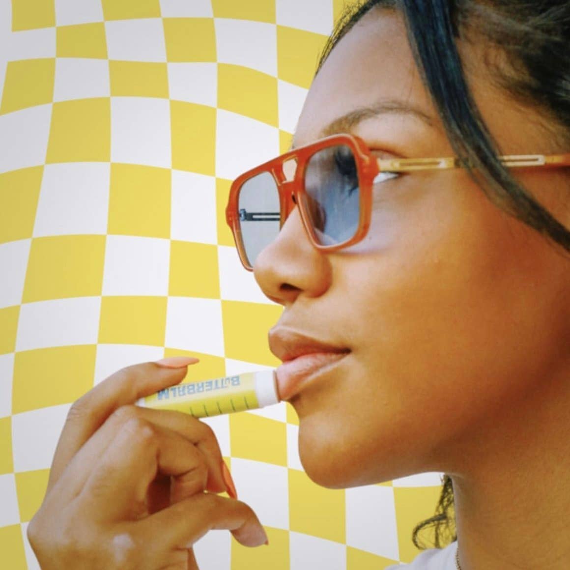 ButterBalm Original Sweet Cream Lip Balm with a model  at Addison West