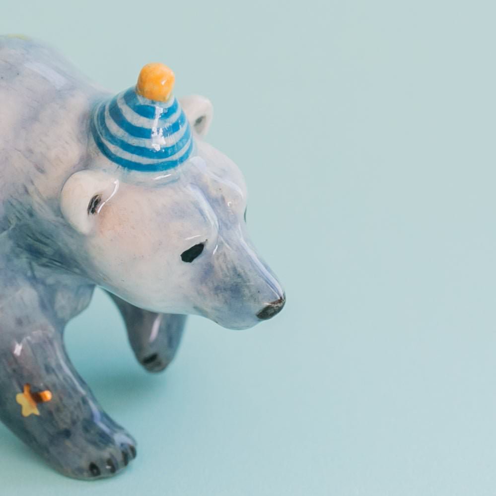Camp hollow Galaxy Bear Cake Topper on a blue background at Addison West