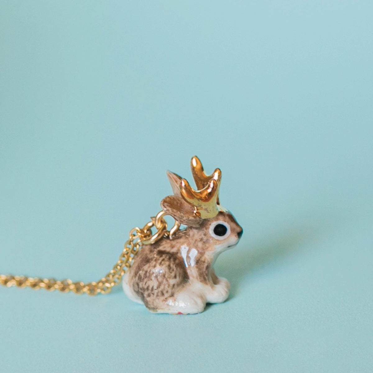 Camp Hollow Jackalope Necklace on a blue background at Addison West