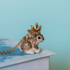 Camp Hollow Jackalope Necklace on a blue background at Addison West