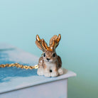 Camp Hollow Jackalope Necklace on a blue background at Addison West