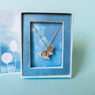 Camp Hollow Jackalope Necklace on a blue background at Addison West