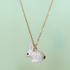 Camp Hollow Porcelain Goldentail Rabbit Necklace on green background.